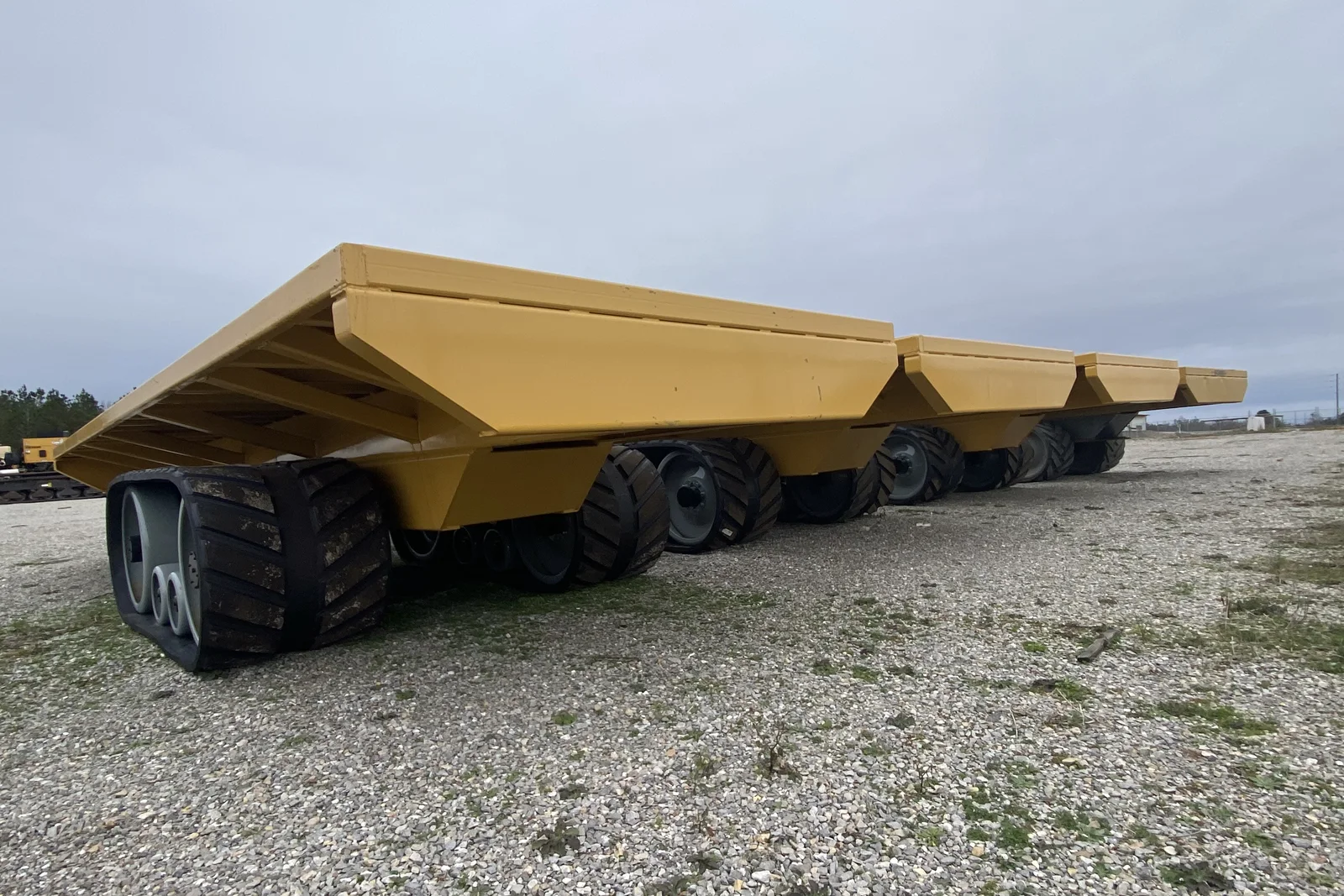 Rubber-track flat-bed trailers lined up in the SEMI yard